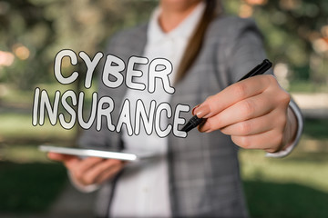 Conceptual hand writing showing Cyber Insurance. Concept meaning protect business and users from Internetbased risks Outdoor background business woman holding laptop and pen