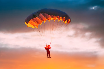 Skydiver On Colorful Parachute In Sunny Sky