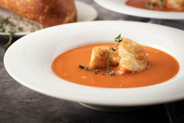 Orange Tomato Soup with Croutons in White Bowl Dinner