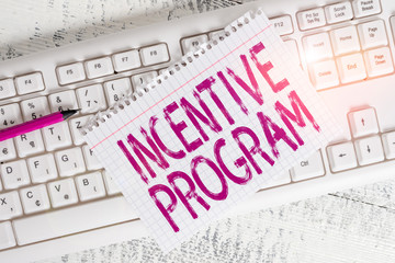 Writing note showing Incentive Program. Business concept for specific scheme used to promote...