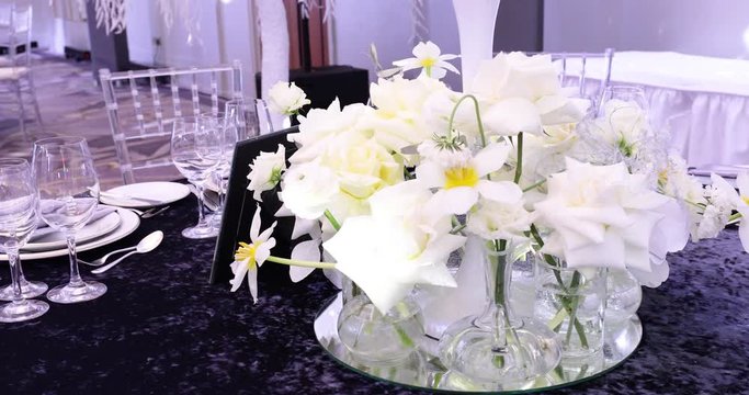 A Festive Table Decorated With White Flowers 