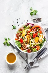  Vegetable salad cherry tomatoes, baked pepper, salad mix and onion with grilled haloumi (halloumi) cheese. Keto diet, healthy food. Light grey stone background. Top view. © valentinamaslova