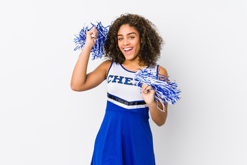 Young cheerleader woman isolated on white background