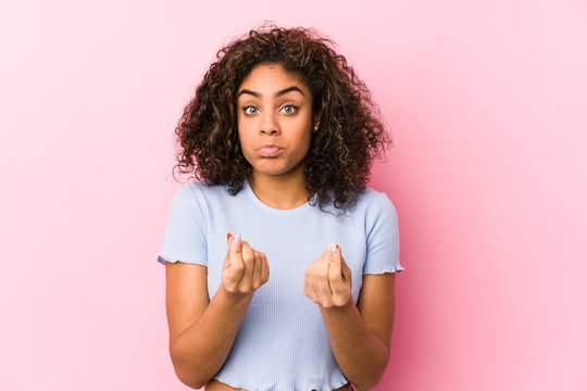 Young African American Woman Against A Pink Background Showing That She Has No Money.