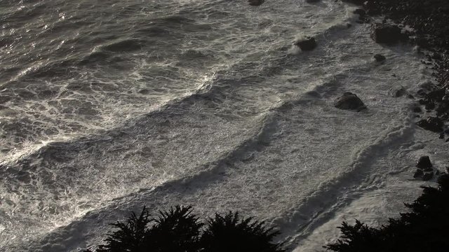 Top view of OceTop view of Ocean waves on golden houran waves on golden hour