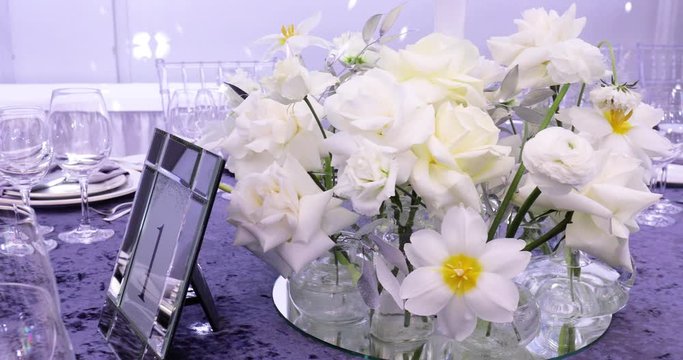 A Festive Table Decorated With White Flowers 
