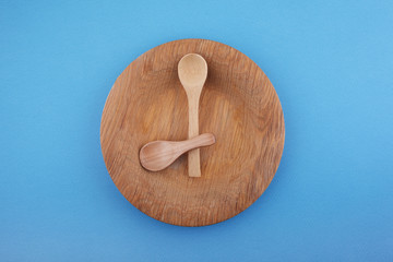 Wooden plate with spoons, Intermittent fasting concept, ketogenic diet, weight loss. Flat lay