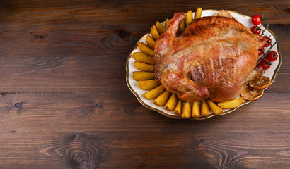 homemade roasted chicken on dark wooden background