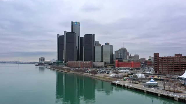 Flying in towards downtown Detroit from over the river on cloudy day.