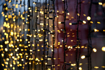 festive background with golden garland with soft focus