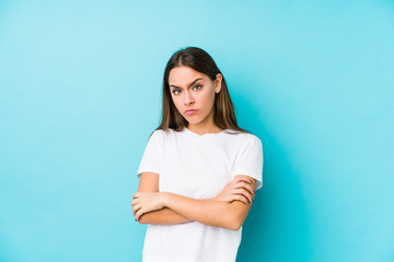 Young caucasian woman  isolated unhappy looking in camera with sarcastic expression.