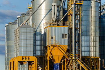 A large modern plant for the storage and processing of grain crops. view of the granary on a sunny day against the blue sky. End of harvest season.