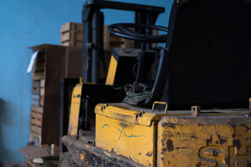 Old forklift, workshop, yellow closeup