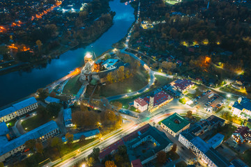Grodno, Belarus. Night Aerial View Of Hrodna Cityscape Skyline. Popular Famous Historic Landmarks In Lightning. Castles And Fire Lookout Tower.