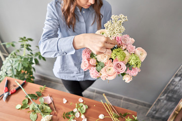 Education in the school of floristry. Master class on making bouquets. Summer bouquet. Learning flower arranging, making beautiful bouquets with your own hands. Flowers delivery