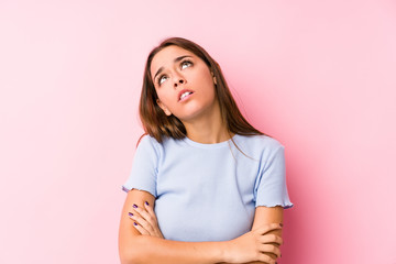 Young caucasian woman wearing a ski clothes isolated tired of a repetitive task.