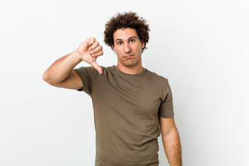 Mature handsome man isolated showing a dislike gesture, thumbs down. Disagreement concept.