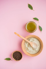 Cosmetic bath salt, grape gomaj for the face, coffee scrub for the body on a pink background.