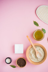 Fototapeta na wymiar Cosmetic bath salt, grape gomaj for the face, coffee scrub for the body on a pink background.