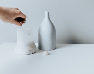 Person putting essential oils into diffuser