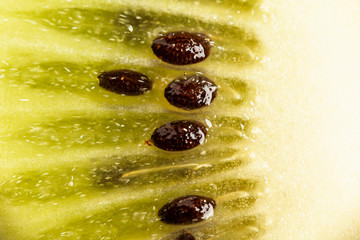 Green kiwi fruit background. Texture of tropical juice and healthy dessert.