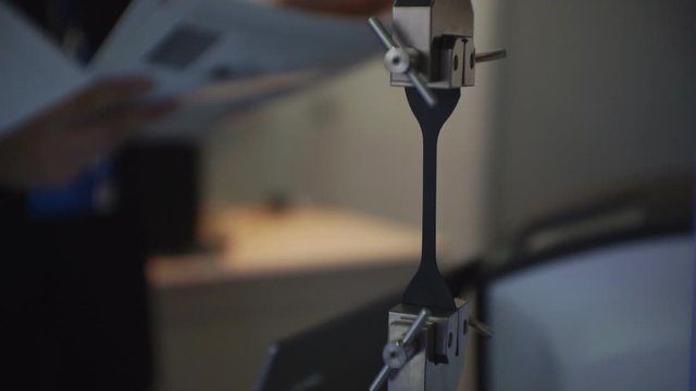 Presentation of a material strength testing machine. The conclusion of the transaction in the background.1920 X 1080 Full Hd.