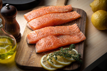 seasoned salmon fillet on wooden cutting board