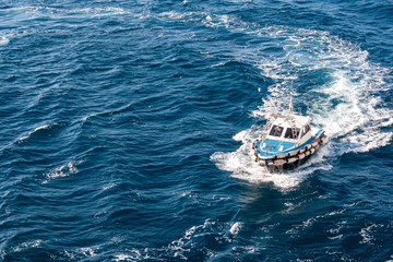 Pilot Boat making a U turn curve viewed from above from a birds eye view