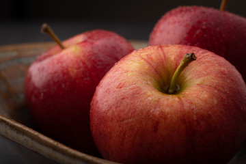 Closeup of 3 Red Apples in a Ceramic Bowl