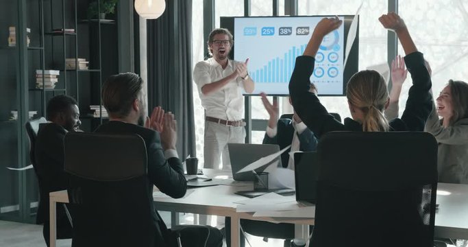 Group of Business People after Successful Teamwork, Finishing Great Project, Throwing Up Papers. Smiling and Laughing at the Modern Office. Sitting in the Meeting Room. Having Good Investors.