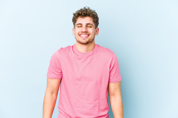 Obraz premium Young blond curly hair caucasian man isolated laughs and closes eyes, feels relaxed and happy.