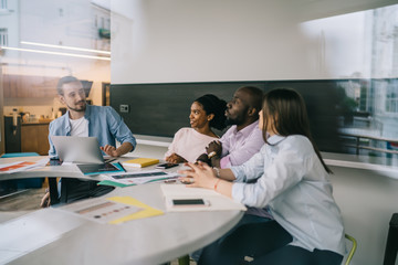 Employees communicating at work in office