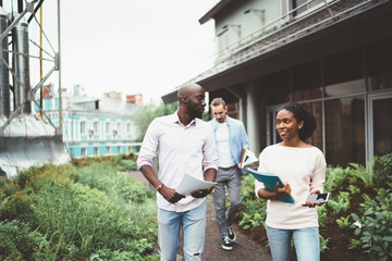Employees chatting happily walking on terrace