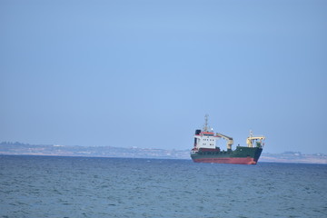 Fototapeta premium Seascape with a boat in the Mediterranean Sea from Larnaca Cyprus