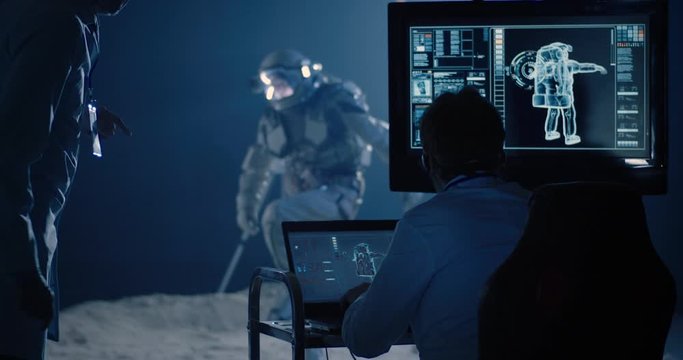 Astronaut and scientists testing spacesuit mobility