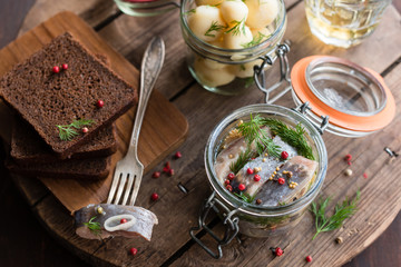Marinated or Pickled Herring with Pink Peppercorn, Mustard Seeds and Dill in Glass Jar