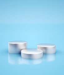 Three silver pedestals for product placement at minimal blue studio background. 3D render