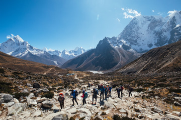 Large expedition members grouon Everest Base Camp trekking route near Dughla 4620m. Backpackers...