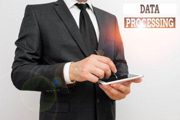 Conceptual hand writing showing Data Processing. Concept meaning collection and manipulation of items of data to produce Male human wear formal work suit hold smartphone using hand