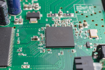 Green printed electronic circuit board  having small electronic components and chips.