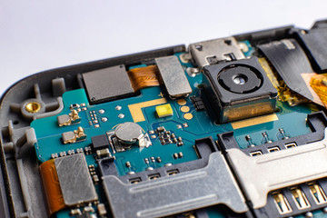 Blue green printed electronic circuit  board of a smartphone phone having small electronic...