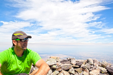 Man with a cap over a hill with stones in Spain