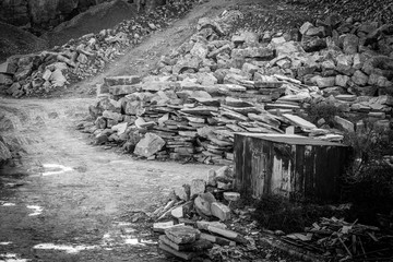 Road tracks in stone quarry with old building