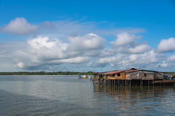 Port of transport of people with houses mounted on winged wooden piles of the transit bridge. Buenaventura Colombia.