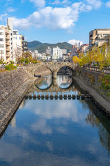 Megane Bridge (Spectacles Bridge) in sunny day with beautiful blue sky reflection on surface. one...