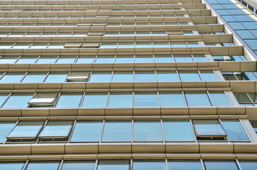 Fragment of scyscraper office building with close up on windows, seamless pattern. view from bottom