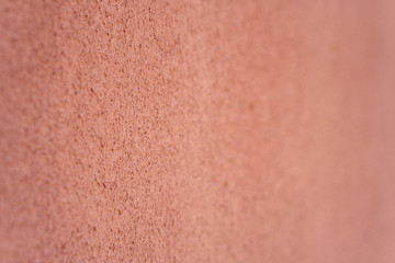 Empty background. Orange wall, porous texture. Soft focus.