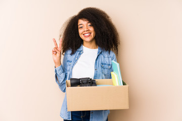 Young afro woman moving home isolated Young afro woman showing number two with fingers.