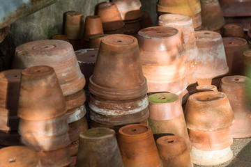 Used old empty terracotta/clay flower pots in the garden, close up. 