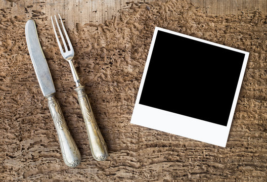 a polaroid photo with knife and fork